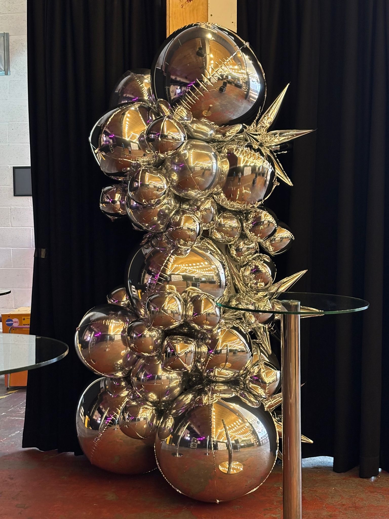Silver foil balloon column with starburst balloons built for ITV’s 70th birthday