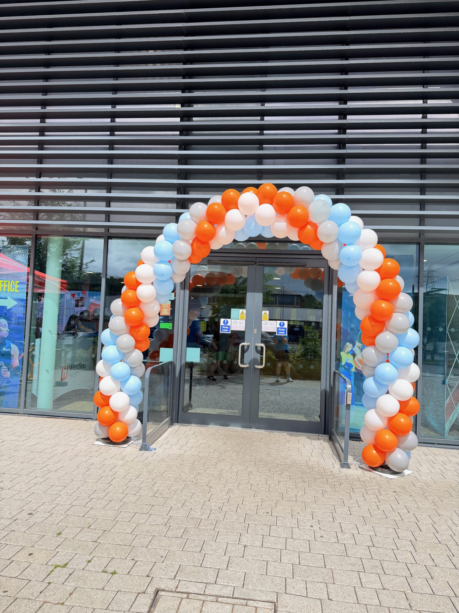 Westfield Health Westfest balloon décor in brand colours at Canon Arena Sheffield